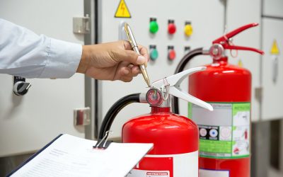 Engineer are inspection Fire extinguisher in fire control room for prevention emergency, rescue and safety or fire extinguisher training and anti-fire protection concept.